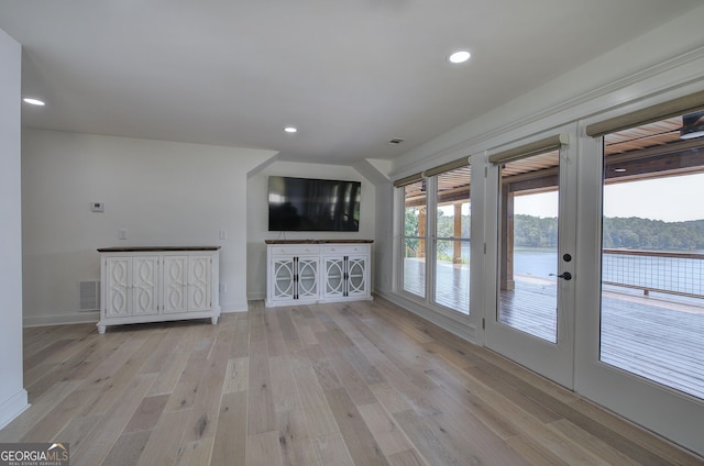 unfurnished living room with french doors and light wood-type flooring