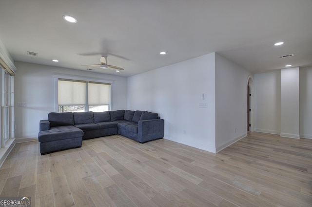 living room featuring light hardwood / wood-style floors and ceiling fan