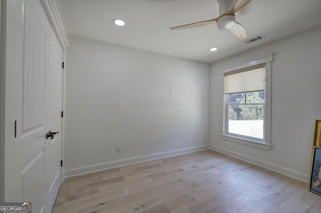 spare room with light hardwood / wood-style floors and ceiling fan