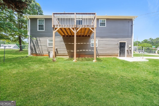 rear view of property featuring a yard