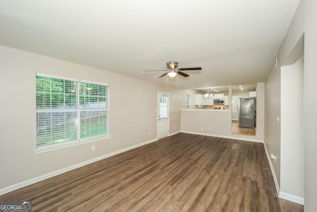 unfurnished living room with ceiling fan and dark hardwood / wood-style floors