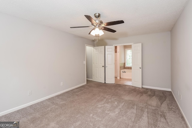 unfurnished bedroom with carpet, ceiling fan, and a textured ceiling