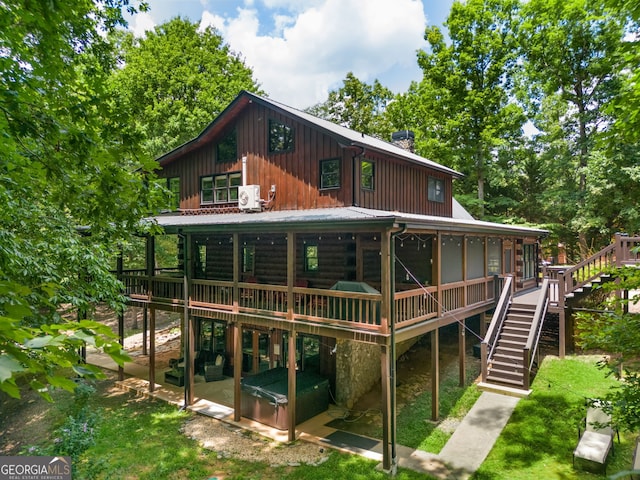 rear view of property featuring a patio area and a deck