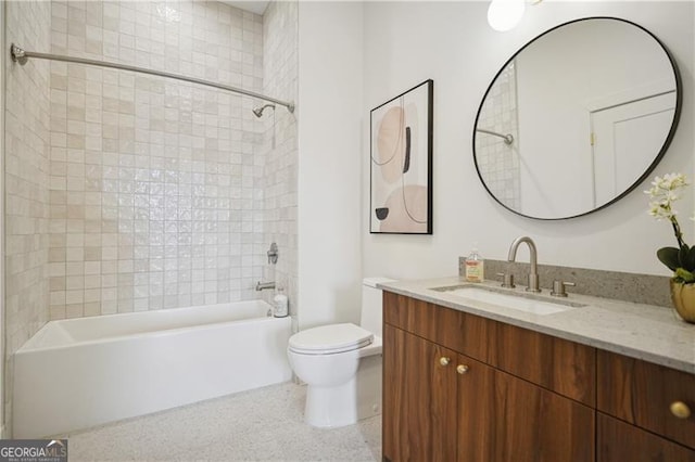 full bathroom with tiled shower / bath, vanity, and toilet