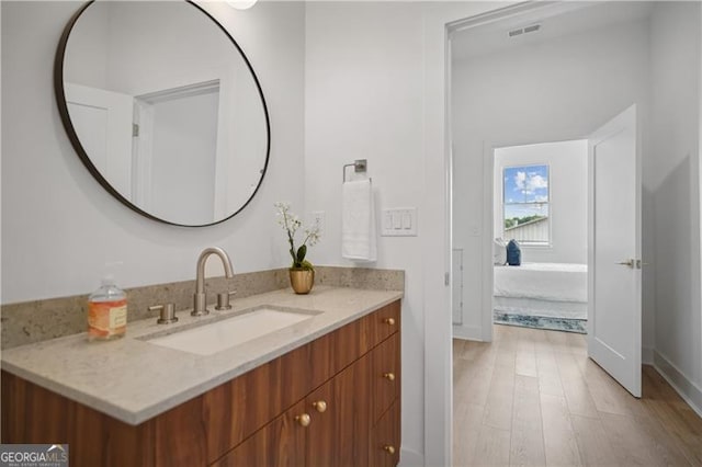 bathroom with vanity and hardwood / wood-style flooring