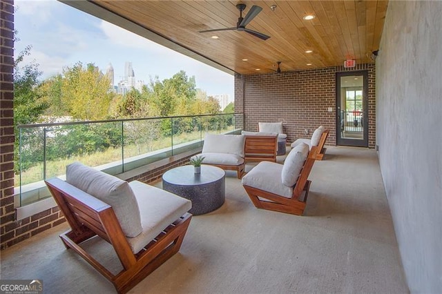 balcony with an outdoor living space and ceiling fan