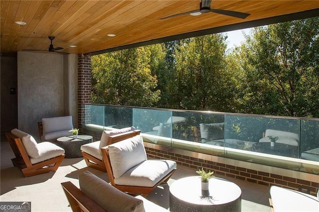 view of patio with a balcony and ceiling fan