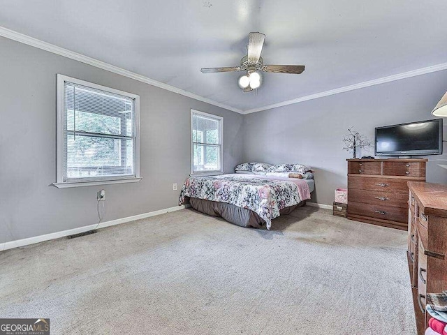 bedroom featuring ceiling fan, ornamental molding, and light colored carpet