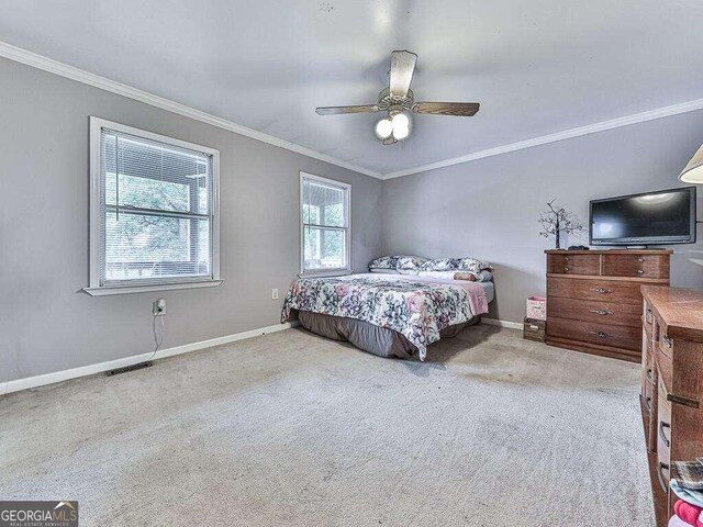 bedroom featuring carpet flooring, baseboards, and ornamental molding