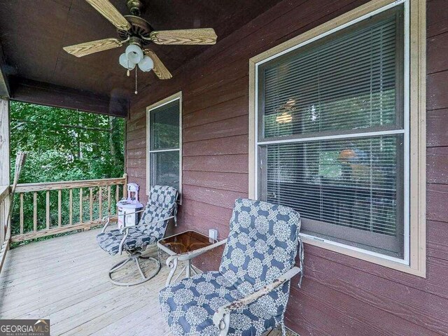 wooden deck with a ceiling fan and covered porch