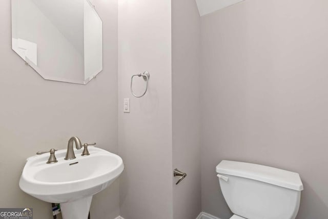 bathroom featuring sink and toilet