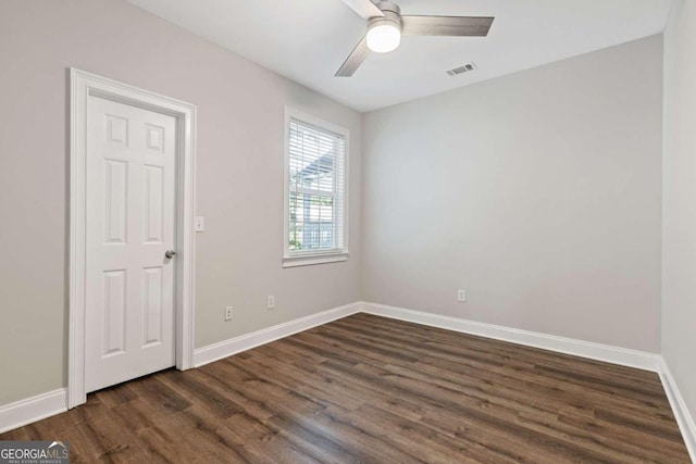 spare room featuring ceiling fan and dark wood-type flooring