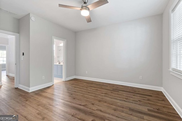 empty room featuring dark hardwood / wood-style flooring and ceiling fan