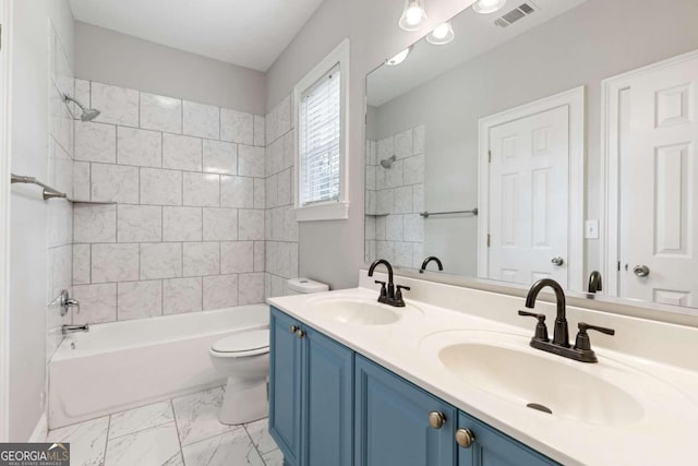 full bathroom featuring vanity, toilet, and tiled shower / bath