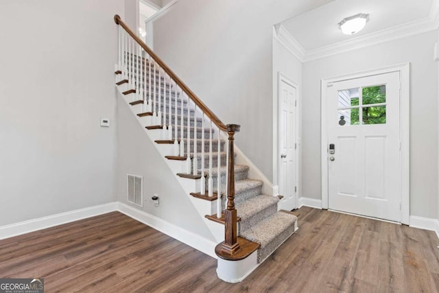 entrance foyer with hardwood / wood-style flooring and crown molding