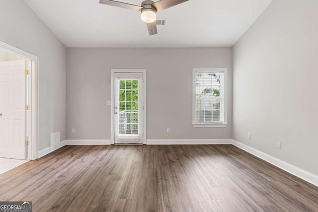 unfurnished room with hardwood / wood-style flooring and ceiling fan