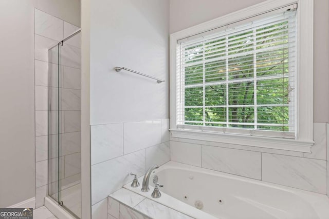 bathroom featuring separate shower and tub and plenty of natural light