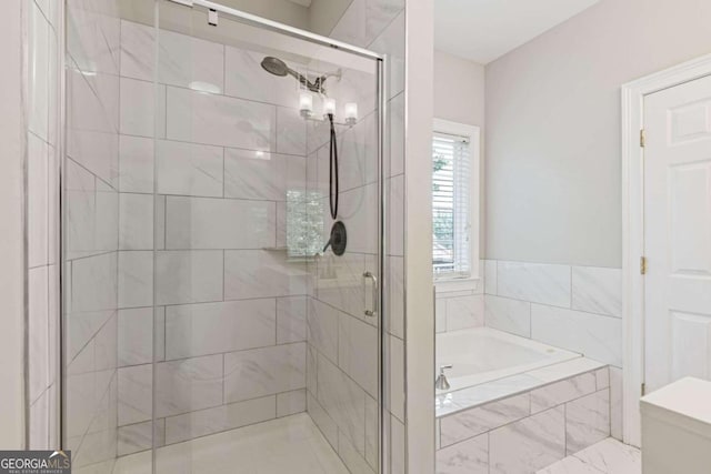 bathroom with shower with separate bathtub