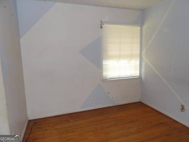 spare room featuring hardwood / wood-style flooring