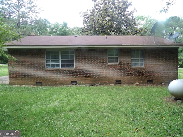 view of side of home featuring a lawn