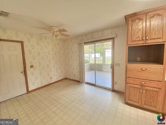 unfurnished dining area with ceiling fan and light tile patterned floors