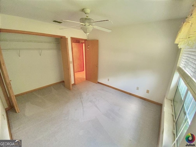 unfurnished bedroom featuring ceiling fan, visible vents, baseboards, a closet, and carpet