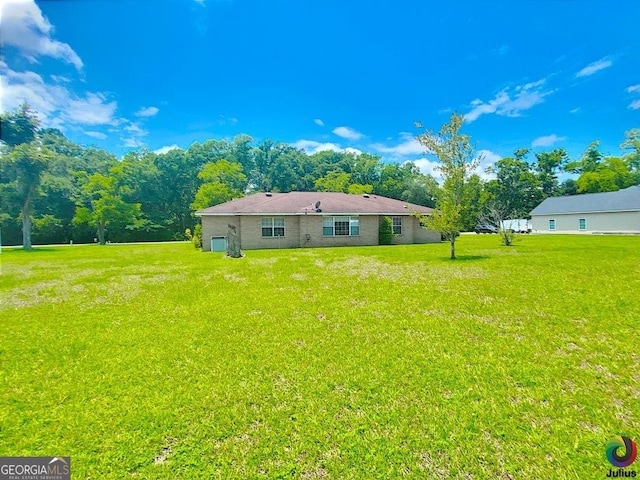 rear view of property with a yard