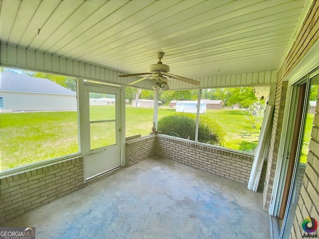 unfurnished sunroom featuring ceiling fan