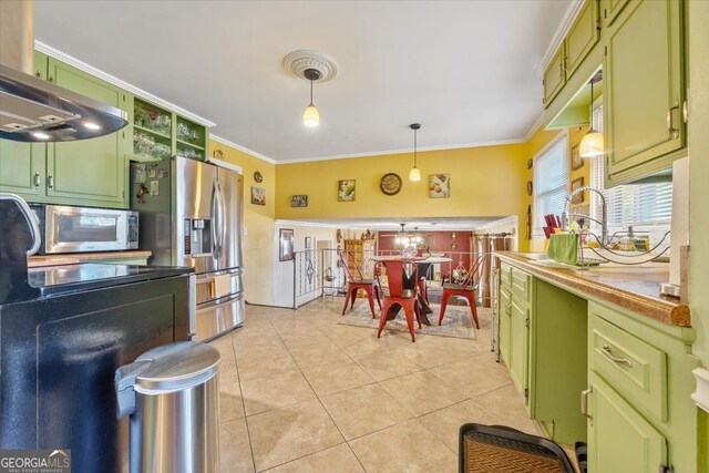 kitchen with appliances with stainless steel finishes, decorative light fixtures, green cabinetry, and light tile patterned floors