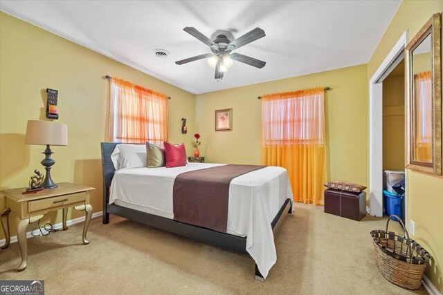 bedroom featuring a closet, carpet flooring, and ceiling fan