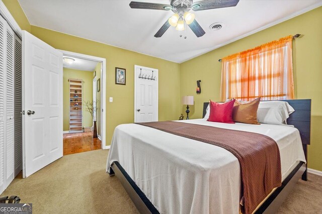 bedroom with a closet, carpet floors, and ceiling fan