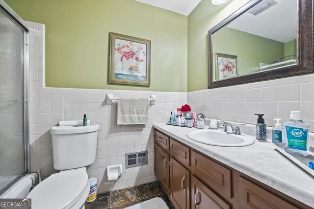 bathroom featuring tile walls, tasteful backsplash, and toilet