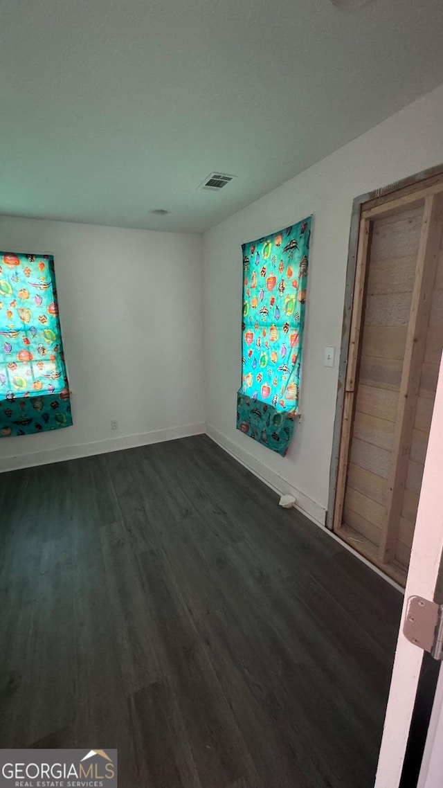 unfurnished room featuring dark hardwood / wood-style floors