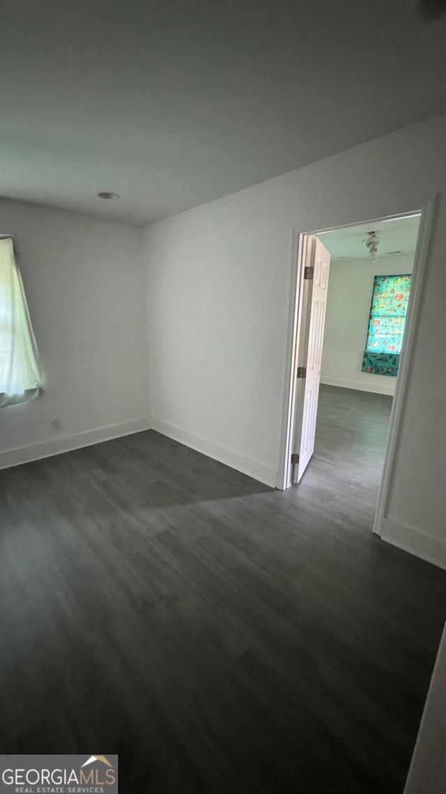 empty room featuring dark wood-type flooring