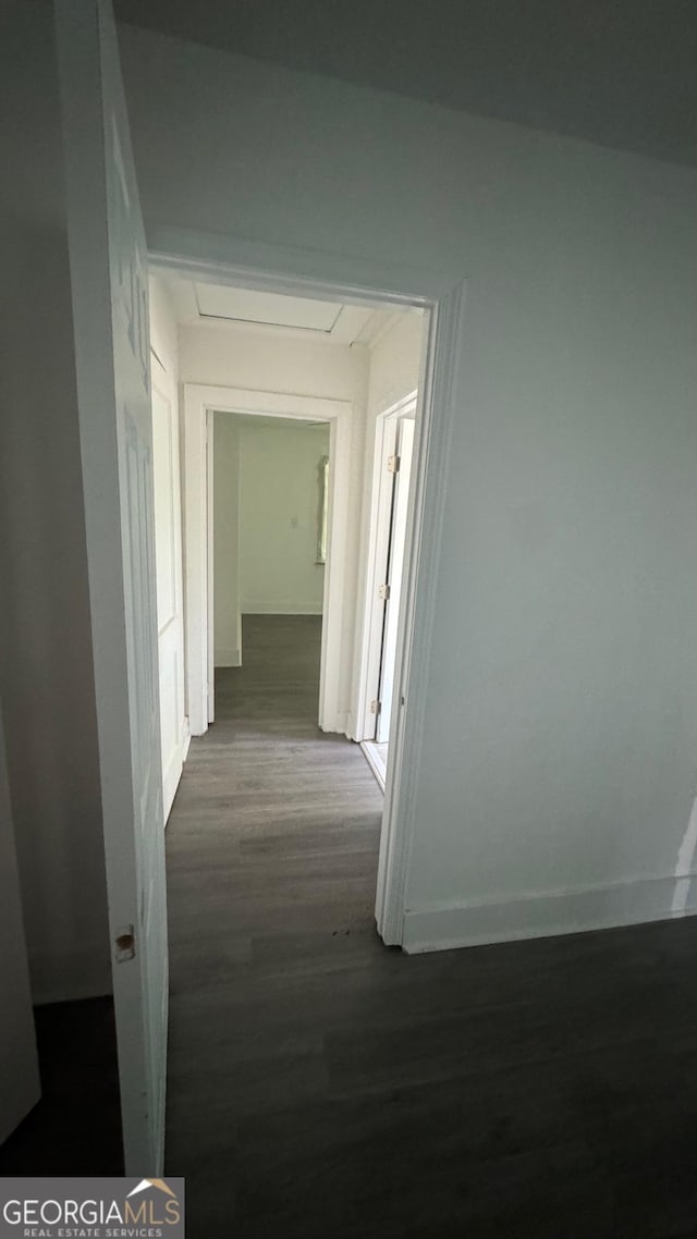 hallway with dark hardwood / wood-style floors