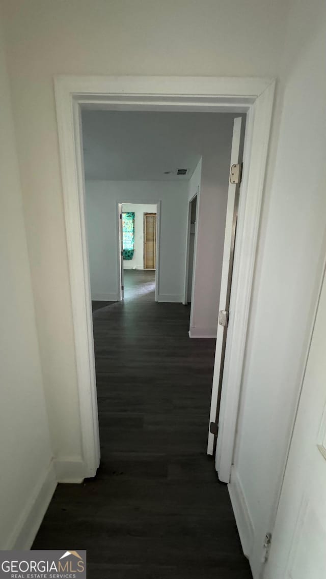 corridor featuring dark hardwood / wood-style floors