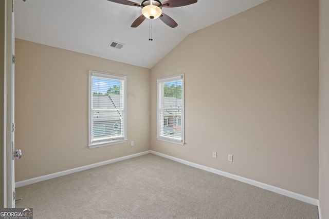 carpeted spare room featuring ceiling fan and lofted ceiling