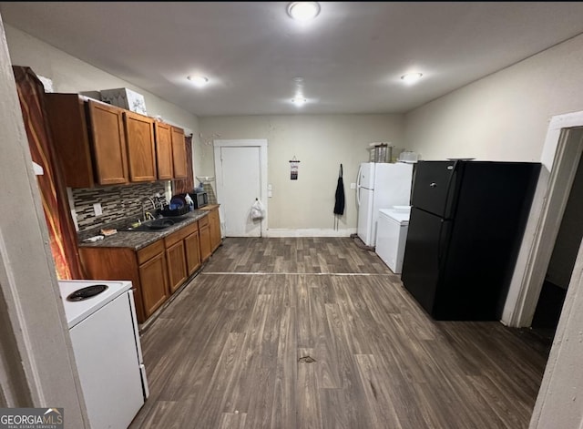 kitchen featuring white appliances, dark hardwood / wood-style floors, tasteful backsplash, and sink