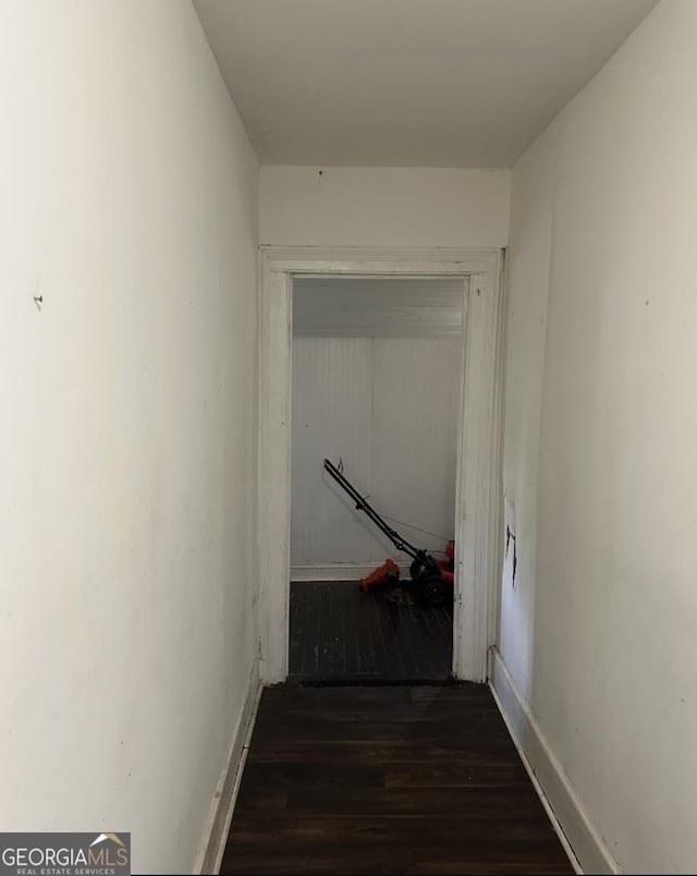 corridor featuring dark hardwood / wood-style flooring