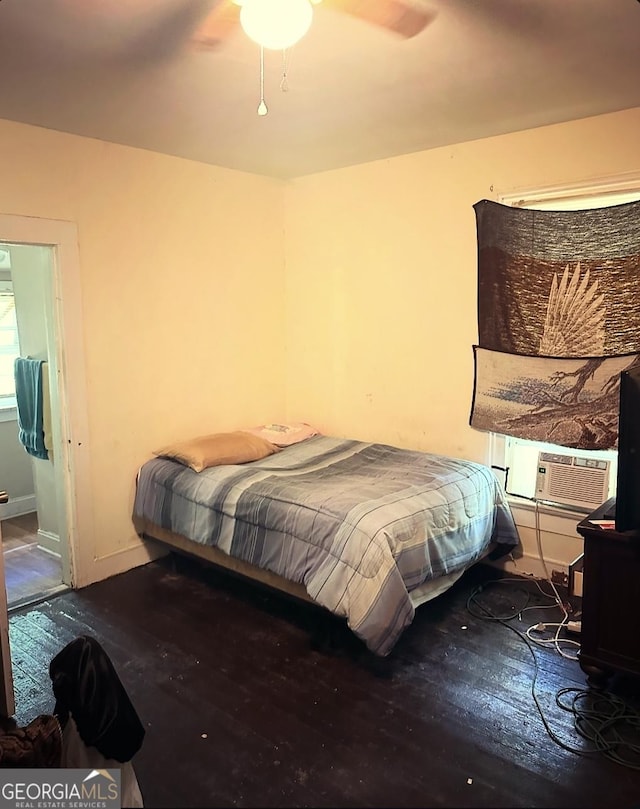 bedroom with hardwood / wood-style floors, ceiling fan, and cooling unit