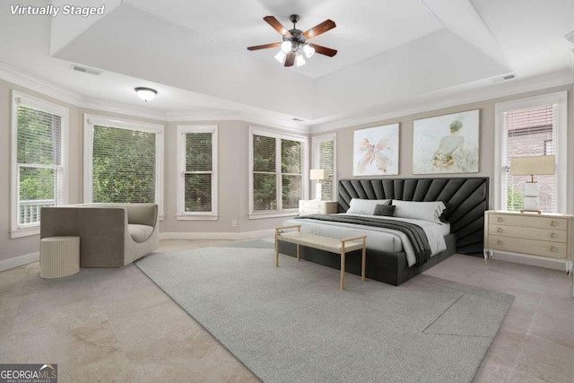 tiled bedroom with multiple windows, crown molding, ceiling fan, and a raised ceiling