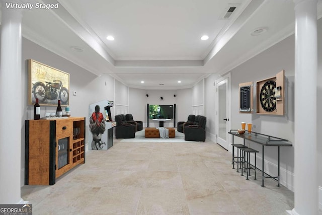 interior space with light tile patterned floors, crown molding, and a tray ceiling