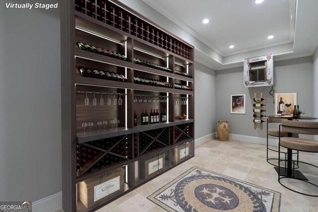 wine room with an AC wall unit, crown molding, light tile patterned floors, and a tray ceiling