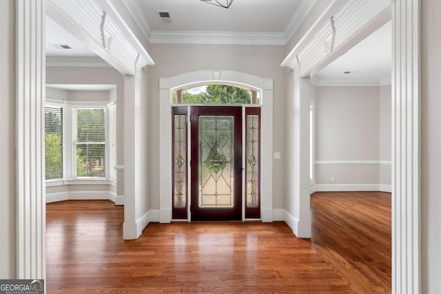 entrance foyer with crown molding and hardwood / wood-style floors