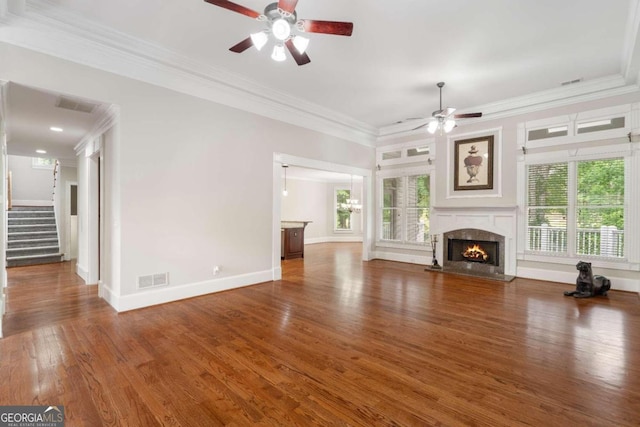 unfurnished living room with a premium fireplace, a wealth of natural light, ceiling fan, and dark hardwood / wood-style floors