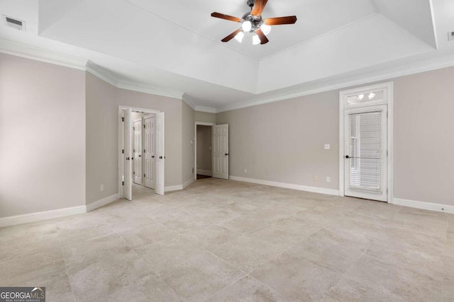 unfurnished bedroom with ornamental molding, light tile patterned flooring, ceiling fan, and a tray ceiling