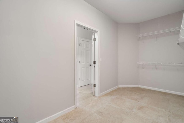 spacious closet with light tile patterned floors