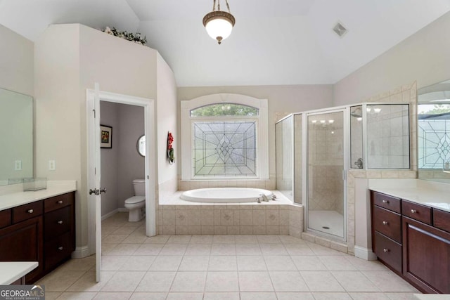 full bathroom featuring tile patterned floors, vanity, plus walk in shower, and toilet