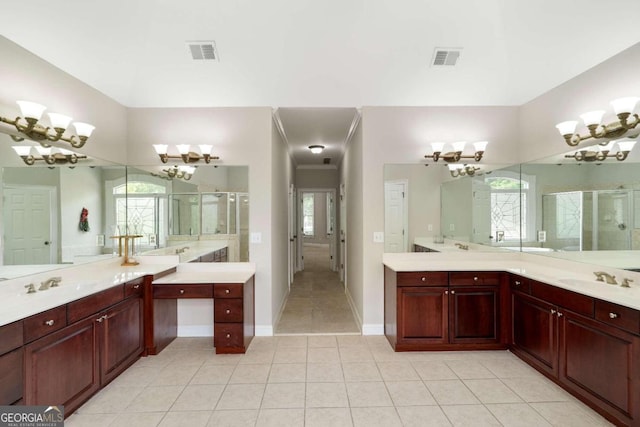 bathroom featuring tile patterned flooring, a healthy amount of sunlight, and double sink vanity