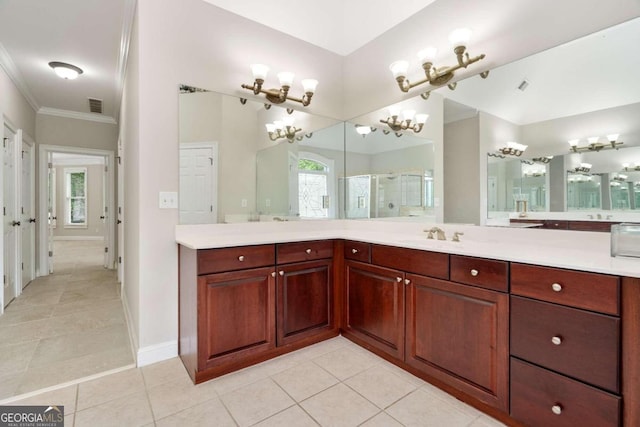 bathroom with vanity, crown molding, a chandelier, and tile patterned floors